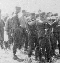 Men_with_an_unidentified_unit_execute_a_group_of_Soviet_civilians_kneeling_by_the_side_of_a_mass_grave 2.jpg